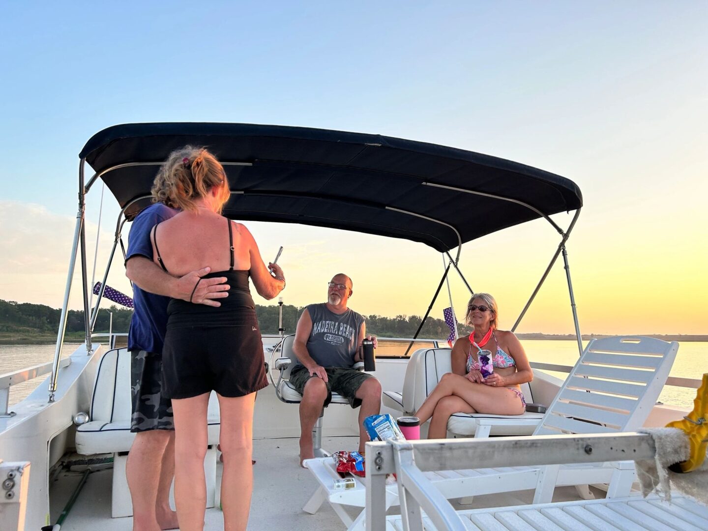 A group of people sitting on the deck of a boat.