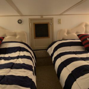 A couple of beds in a room with pillows.