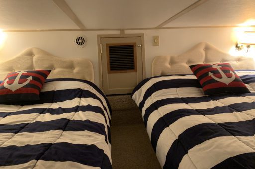 A couple of beds in a room with pillows.