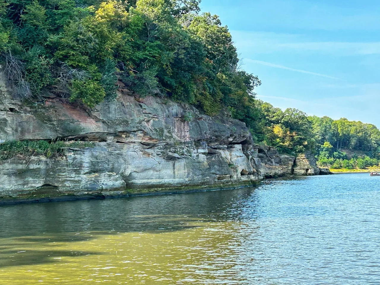 A body of water with trees and rocks on it.