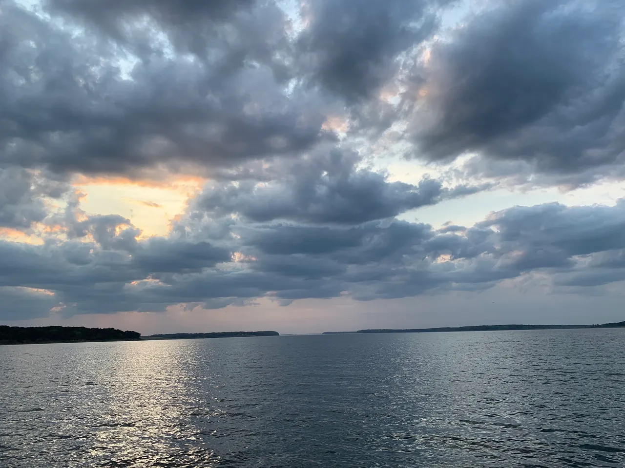 A cloudy sky over the water with some clouds