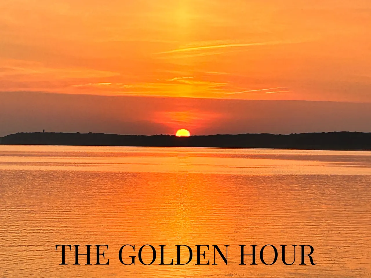 A sunset over the ocean with the words " the golden hour ".