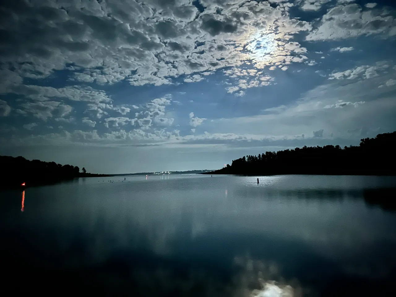 A body of water with clouds in the sky.