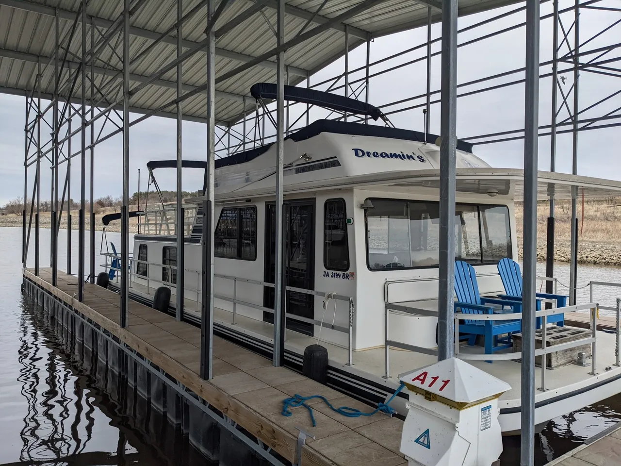 A white boat is parked in the dock.