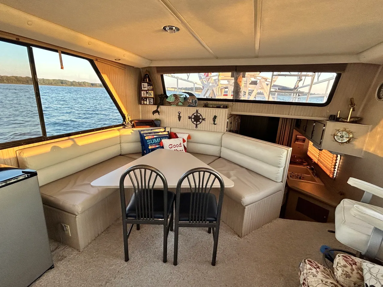 A boat with two chairs and a table in the middle.