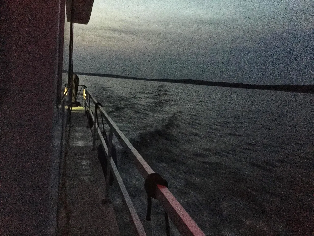 A boat is in the water at night.